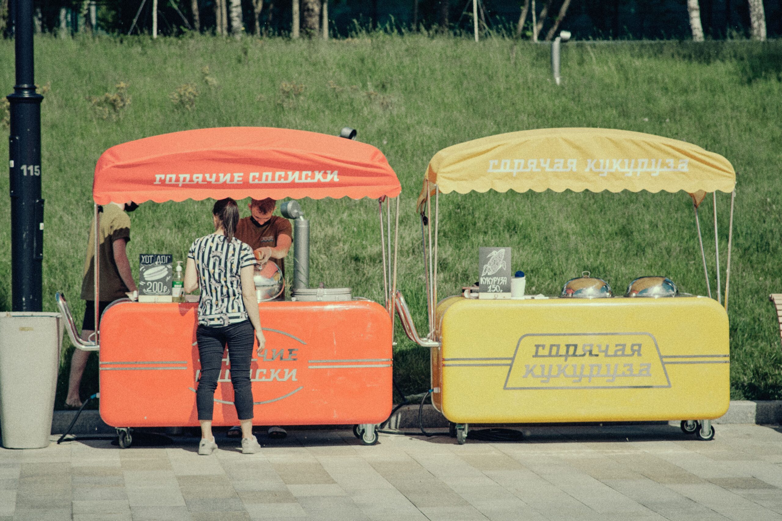 A vibrant scene of street food vendors in Moscow serving customers outdoors.
